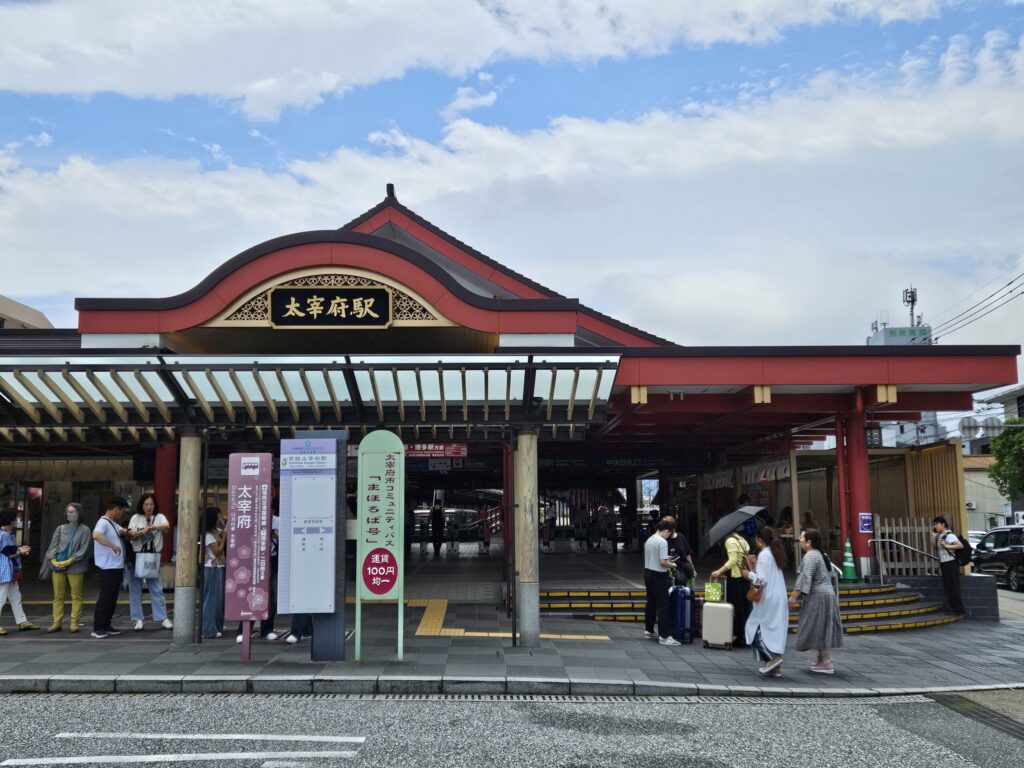 Exterior of Nishitetsu Dazaifu Station on a sunny day, gateway to Dazaifu Tenmangu Shrine.