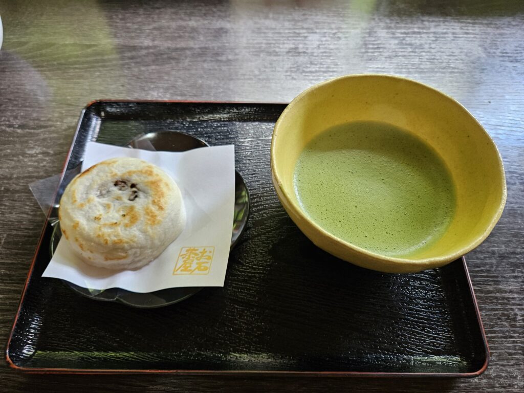 A traditional tea set at Oishi Chaya behind Dazaifu Tenmangu Shrine, featuring Umegae Mochi and a bowl of matcha.