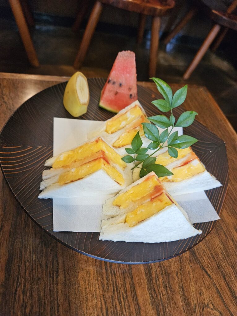 Café Ran Kan’s popular egg sandwich plate with banana and watermelon, near Dazaifu Tenmangu.
