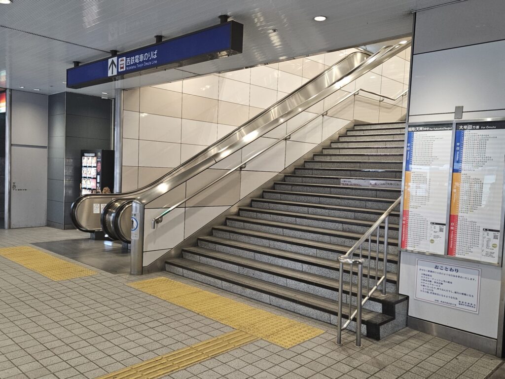 Stairs in front of the ticket gates at Nishitetsu Yakuin Station, used for transfers to the Dazaifu Line.