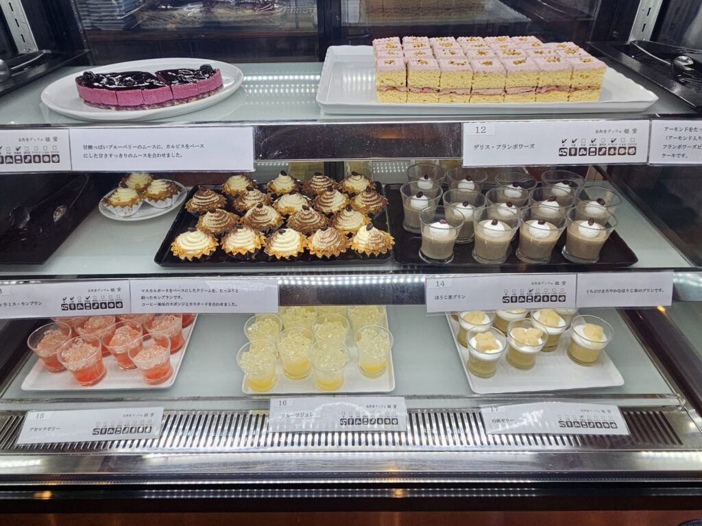 Dessert showcase 1 at the buffet in Tenpai no Sato, Chikushino, near Dazaifu Tenmangu Shrine — lined with cakes such as blueberry cake.