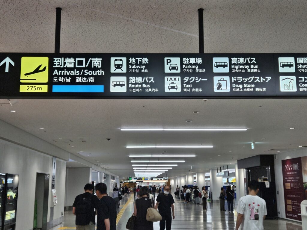 Sign showing Arrivals South direction inside Fukuoka Airport Domestic Terminal.
