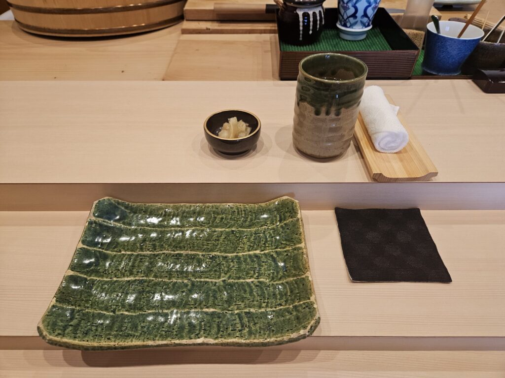 Homemade gari (pickled ginger) and the chef’s custom three-tiered counter at Gin Sushi in Onojo, near Dazaifu — showing his craftsmanship and care.