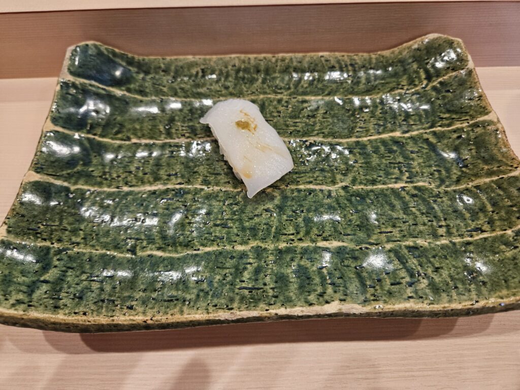 Ika (squid) sushi at Gin Sushi in Onojo, near Dazaifu — translucent and tender, with a hint of yuzu pepper.