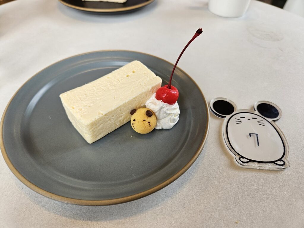 Signature white cheesecake from Chuta no Kissa café, served with a cute “Chuta” character plate.
